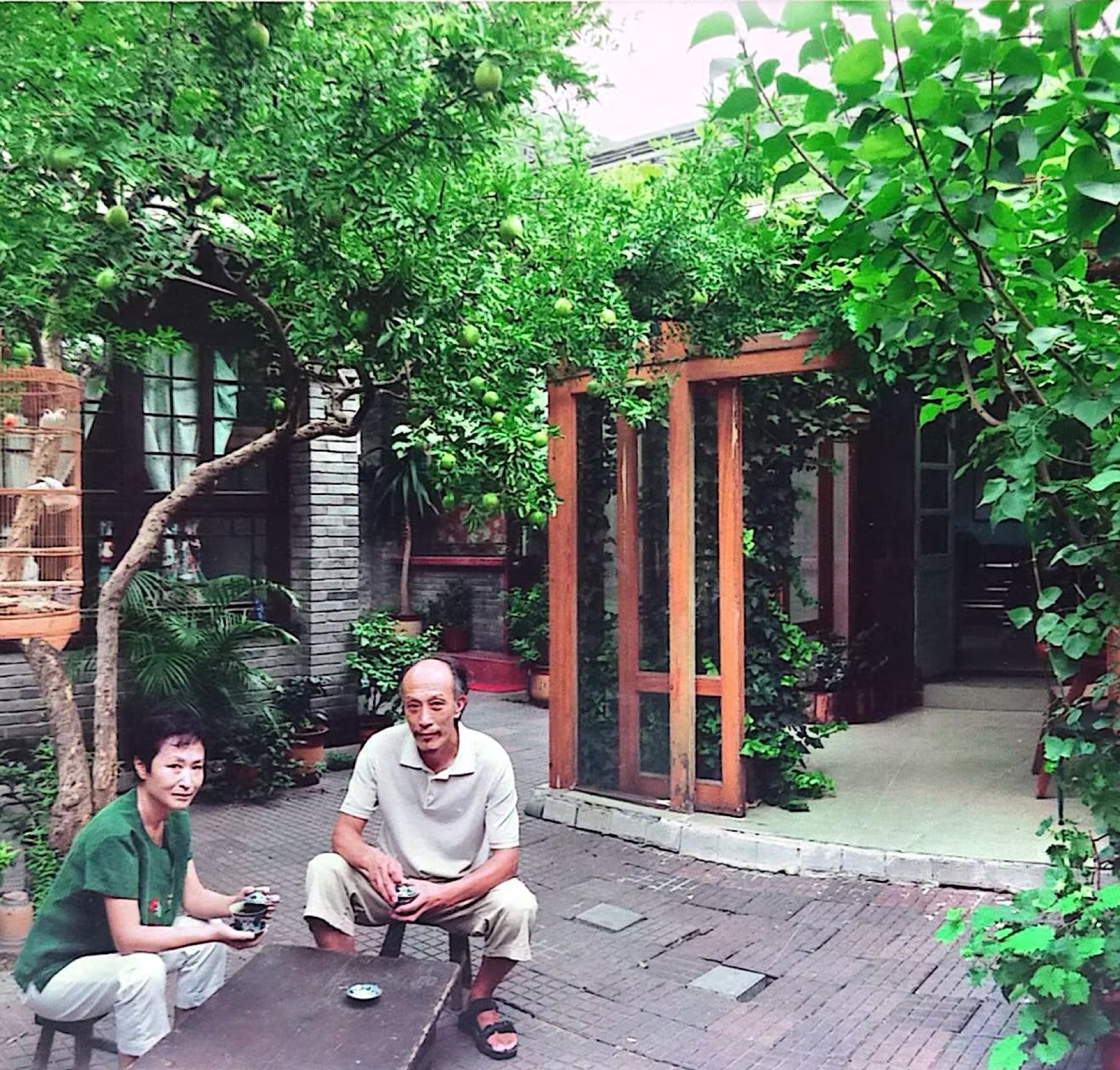 Jing Jichang and Wang Zhixi in the courtyard they restored