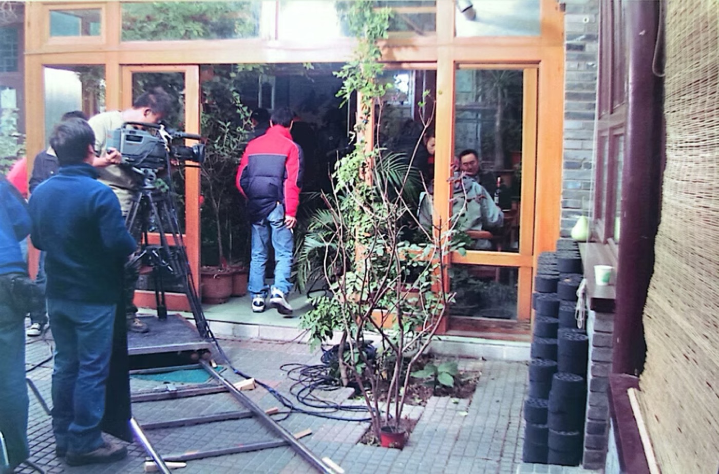 A film crew entering the courtyard