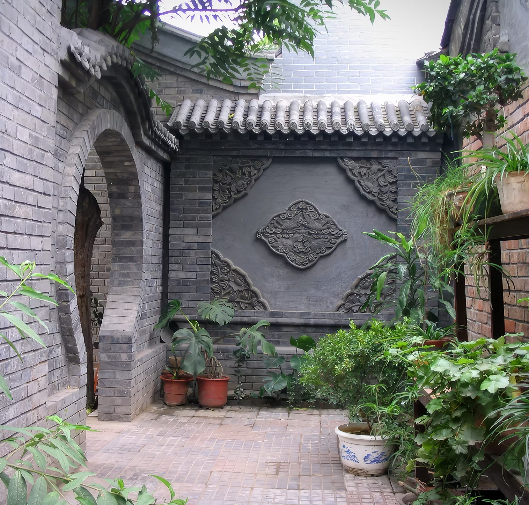 A moon gate opening into the courtyard garden